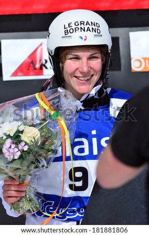 VEYSONNAZ, SWITZERLAND - MARCH 11: Nelly MOENNE LOCCOZ (FRA) on the podium in the Snowboard Cross World Cup: March 11, 2014 in Veysonnaz, Switzerland