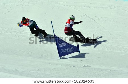 VEYSONNAZ, SWITZERLAND - MARCH 11: BAKES (CZE) leads HUGHES (AUS)in the Snowboard Cross World Cup: March 11, 2014 in Veysonnaz, Switzerland