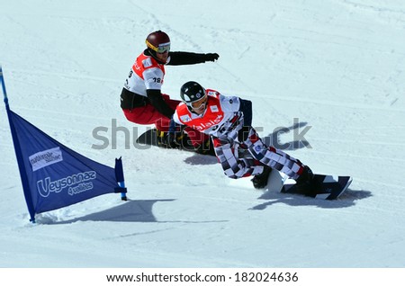 VEYSONNAZ, SWITZERLAND - MARCH 11: OLYUNIN (RUS) leads WATTER (SUI) in the Snowboard Cross World Cup: March 11, 2014 in Veysonnaz, Switzerland