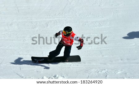 VEYSONNAZ, SWITZERLAND - MARCH 11: Christopher ROBANSKE (CAN) on a fast bend in the Snowboard Cross World Cup: March 11, 2014 in Veysonnaz, Switzerland
