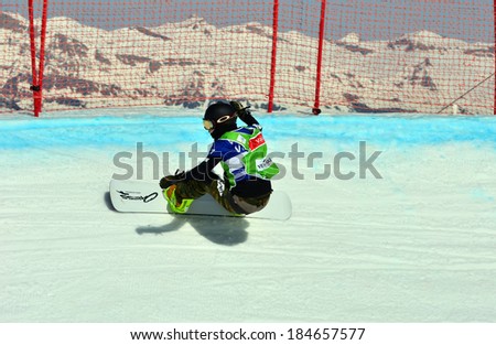 VEYSONNAZ, SWITZERLAND - MARCH 11: Yuka FUJIMORI (JPN) on a fast curve in the Snowboard Cross World Cup: March 11, 2014 in Veysonnaz, Switzerland