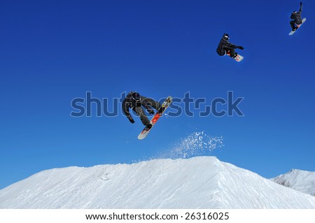 sequence of a snowboarder performing a jump from a snow ramp  and trailing snow behind