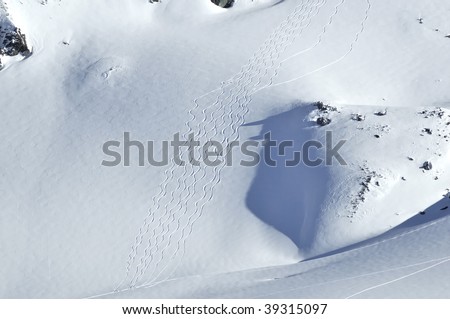 ski turns in powder snow on the rosablanche glacier, made by helicopter skiers