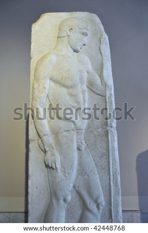 ancient marble sculpture of a beautiful and naked greek athlete holding a javelin