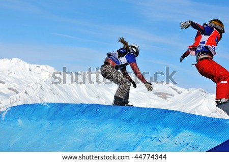 VEYSONNAZ, SWITZERLAND - JANUARY 15: World championship Snowboard cross  finals. Tanja Frieden leads Mellie Francon over the jump. January 15 in Veysonnaz, Switzerland.