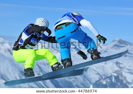 VEYSONNAZ, SWITZERLAND - JANUARY 15:  FIS World Championship Snowboard Cross finals. Finalists Meiler and Gillings jump together.  January 15, 2010 in Veysonnaz, Switzerland