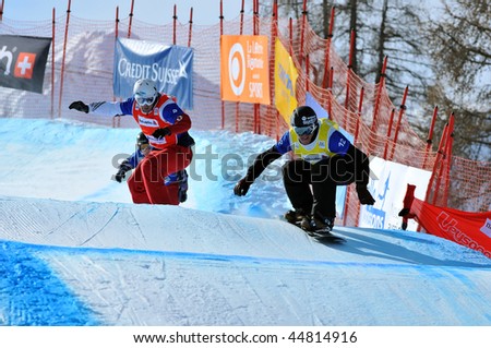 VEYSONNAZ, SWITZERLAND - JANUARY 15: World championship Snowboard cross  finals. Xavier de le Rue leads Nick Baumgartner. January 15 in Veysonnaz, Switzerland.