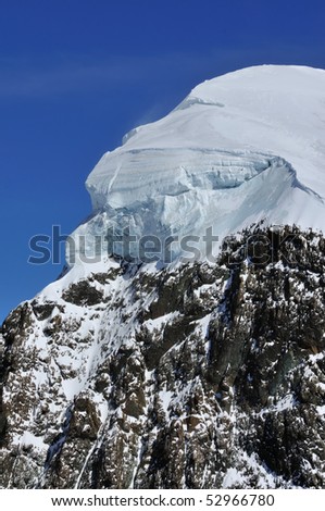 Thick cap of ice on the summit of the Breithorn in the southern swiss alps