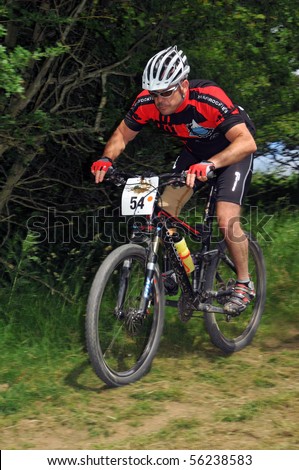 LEDBURY, UK-JUNE 19:An unidentified disabled racer with artificial limb in the  24 hour 2010 Mountain Mayhem mountain bike competition: June 19, 2010 in Ledbury UK