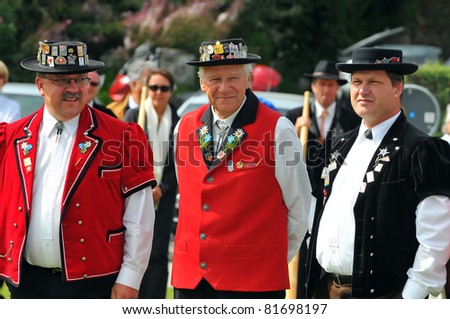 NENDAZ, SWITZERLAND - JULY 24:competition judges in traditional dress at the prize giving of  the 10th International Festival of Alpine horns :  July 24, 2011 in Nendaz Switzerland