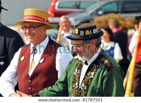 NENDAZ, SWITZERLAND - JULY 24: Finalists Birchler (l) and Bauriedl shake hands at the prize giving ceremony at the 10th International Festival of Alpine horns :  July 24, 2011 in Nendaz Switzerland