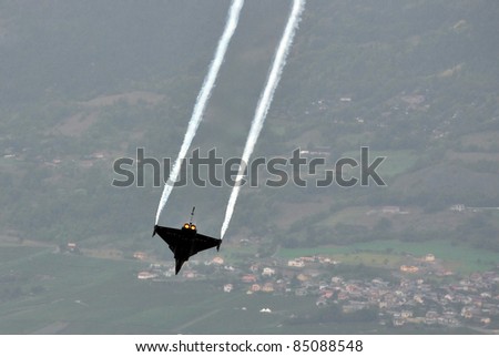 SION, SWITZERLAND - SEPTEMBER 17: Dassault Rafale diving at speed  at the Breitling Air show.  September 17, 2011 in Sion, Switzerland