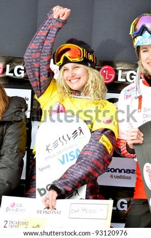 VEYSONNAZ, SWITZERLAND - JANUARY 19: Lindsay Jacobellis (USA) reacts while on the podium to being the new world champion at the FIS World Championship Snowboard Cross finals on January 19, 2012 in Veysonnaz, Switzerland