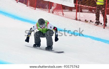 VEYSONNAZ, SWITZERLAND - JANUARY 19: World champion Andrey Baldokov (RUS) in the  FIS World Championship Snowboard Cross finals : January 19, 2012 in Veysonnaz Switzerland