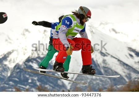 VEYSONNAZ, SWITZERLAND - JANUARY 22: Alex Tuttle (14) jumping with Paul-Henri de le Rue at the FIS World Championship Snowboard Cross finals : January 22, 2012 in Veysonnaz Switzerland