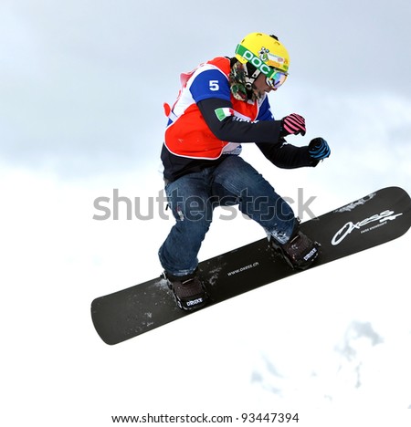 VEYSONNAZ, SWITZERLAND - JANUARY 22: Third place Emanuel Perathoner (ITA) jumping at the FIS World Championship Snowboard Cross finals : January 22, 2012 in Veysonnaz Switzerland