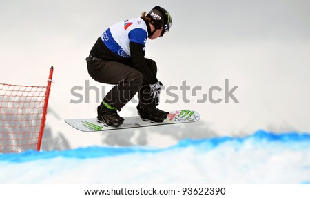 VEYSONNAZ, SWITZERLAND - JANUARY 21: World Champion Nate Hiolland (USA) jumping at the FIS World Championship Snowboard Cross finals on January 21, 2012 in Veysonnaz, Switzerland