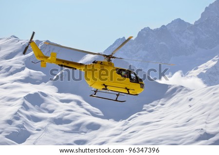 a rescue helicopter in snow covered mountains used to transport injured sports people rapidly from inaccessible mountainous terrain to medical facilities, saving many lives