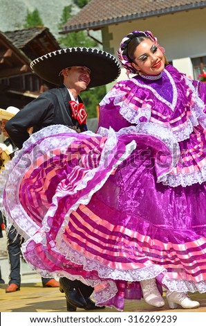 EVOLENE, SWITZERLAND - AUGUST 11: Two mexican dancers from Guadelupe Omexochitl in the CIME mountain culture Festival: August 11, 2015 in Evolene, Switzerland