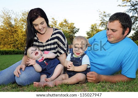 Beautiful young family with twin babies