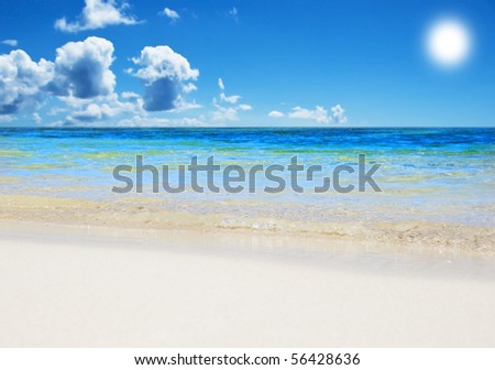 An open tropical island beach with sky and clouds