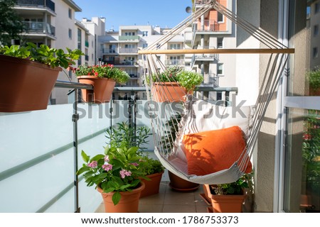 summer balcony with hammock and flowering plants