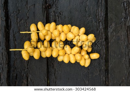 date-palm Fruit on Old wooden  date-palm fruit is grown in areas north and east Thailand