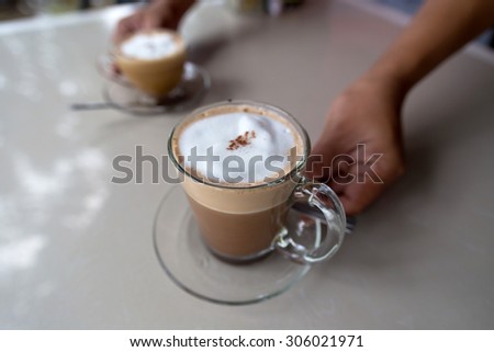 A coffee  cup server on the table.