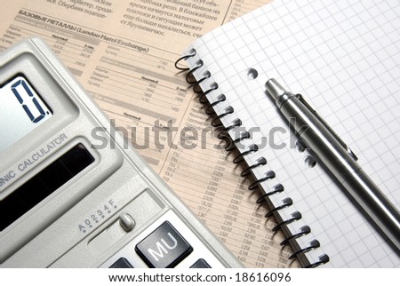 Calculator, pen, notebook and financial newspaper. Conceptual.