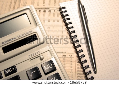Calculator, pen, notebook and newspaper. Financial concept.