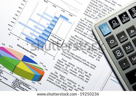 Calculator and stock market report with visual aids.