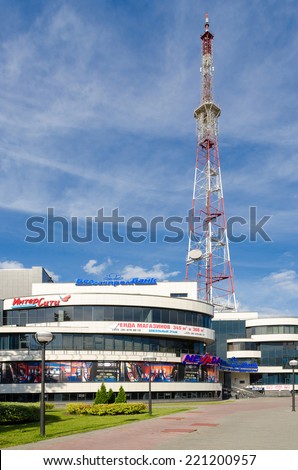 GOMEL, BELARUS -  June 29, 2014: The mast of radio and  television transmitting station and contemporary shopping and entertainment complex in June 29, 2014 in Gomel, Belarus