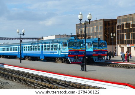 MOGILEV, BELARUS - APRIL 25, 2015: Unidentified people are waiting to board in diesel trains on the platform of the train station in Mogilev, Belarus