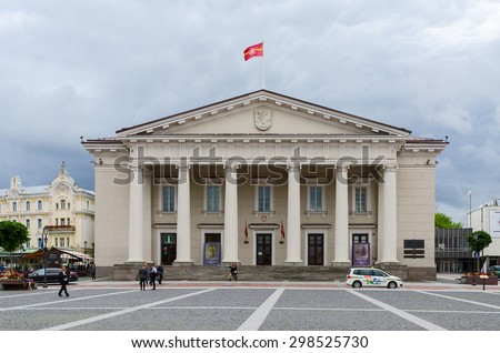 VILNIUS, LITHUANIA - JULY 10, 2015: Unidentified tourists walk on Town Hall Square near Building of Town Hall