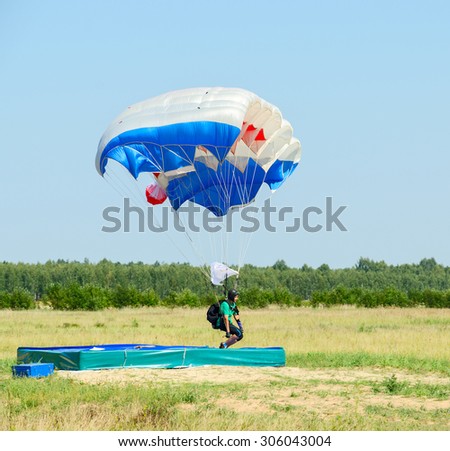 ZYABROVKA, BELARUS - AUGUST 8, 2015: Unknown woman -  skydiver completes a jump landing on the accuracy