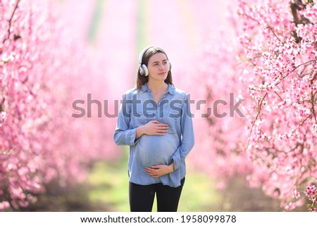 Similar – Image, Stock Photo Crop woman with headphones chatting on smartphone in evening town