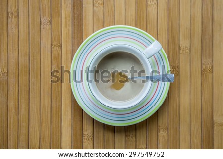 coffee cup on bamboo plate