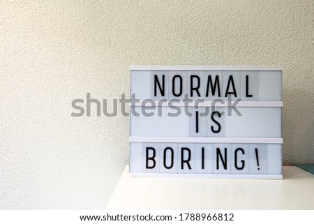Normal is boring written in Light box home decoration, motivational sign retro home, space for text