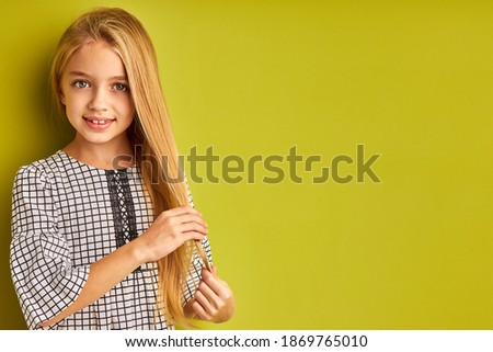 Similar – Image, Stock Photo Long haired young handsome man on a black background with a light illuminating his face, with a flirtatious expression for the camera showing a slight smile