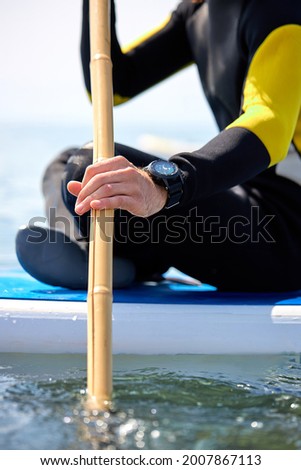 Similar – Image, Stock Photo Pensive man with paddle board before surfing