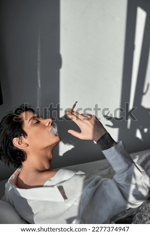 Similar – Image, Stock Photo Adult man smoking cannabis joint