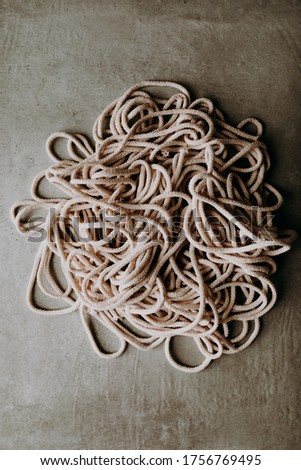 Image, Stock Photo Tangled macrame cord heap on grey background