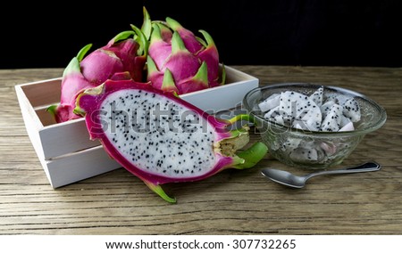 Dragon Fruit in the box. Dragon Fruit on a wooden table. Selective focus.