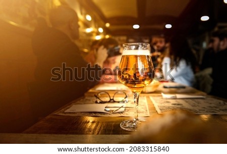 Group of people having lunch at brewery bar restaurant - Close up glass beer on dining table - Brewery and food concept Foto stock © 