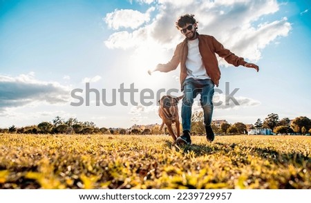 Similar – Image, Stock Photo Man playing with dog on beach
