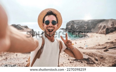 Similar – Image, Stock Photo Male tourist with photo camera standing on rocky lake shore