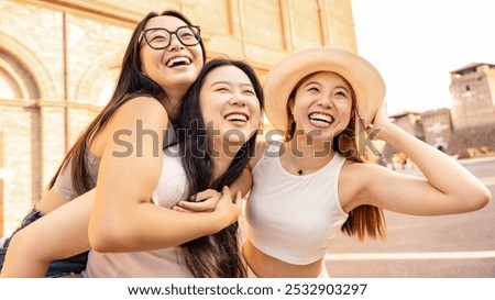 Similar – Image, Stock Photo Delighted female friends walking along street