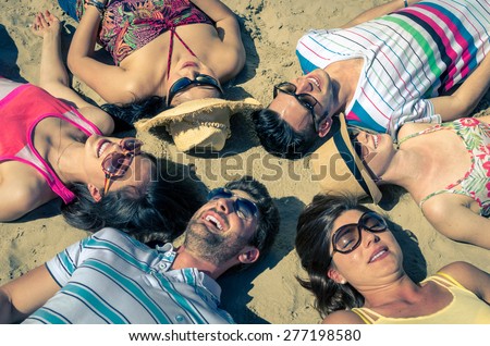 group of friends laughing at sea