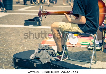 Street artist plays guitar - art, lifestyle and music concept