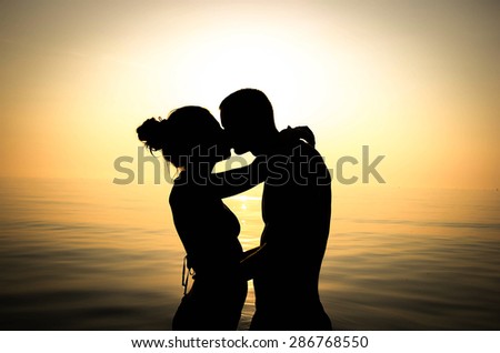 couple in love is kissing at the sea - lifestyle, emotions and people concept